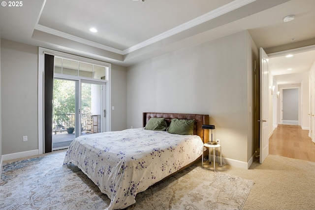 bedroom with crown molding, carpet, access to exterior, and a tray ceiling