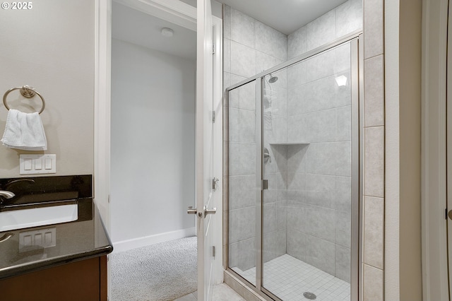 bathroom with vanity and a shower with door