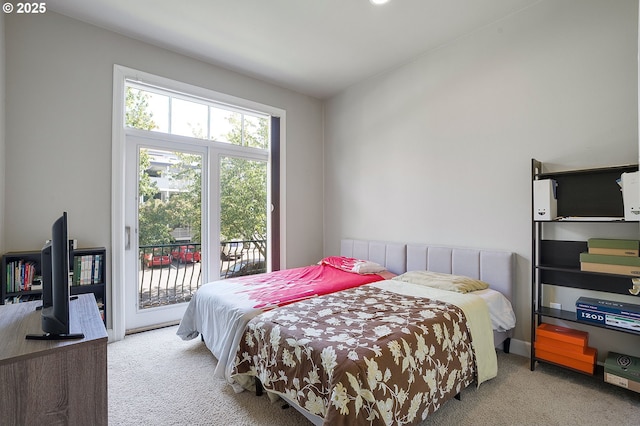 bedroom with light carpet and access to outside