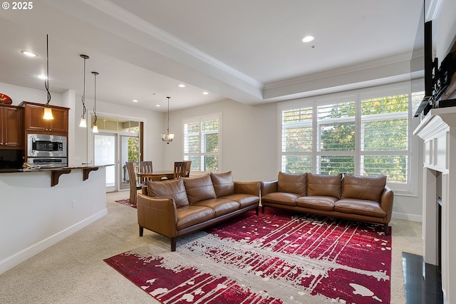 living room with an inviting chandelier and crown molding