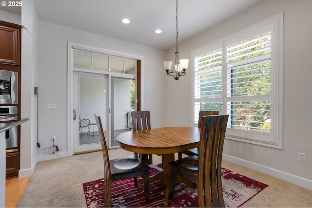 dining area featuring plenty of natural light and a chandelier