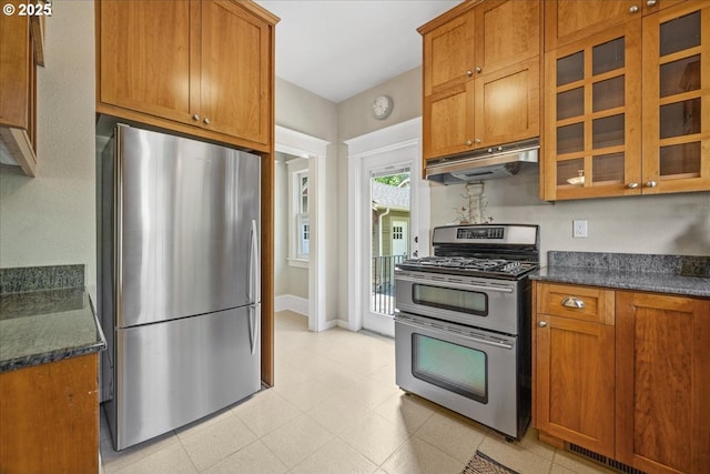 7525 SE 18th Ave, Portland, OR 97202 - kitchen with stainless steel appliances, under cabinet range hood, brown cabinetry, and glass insert cabinets