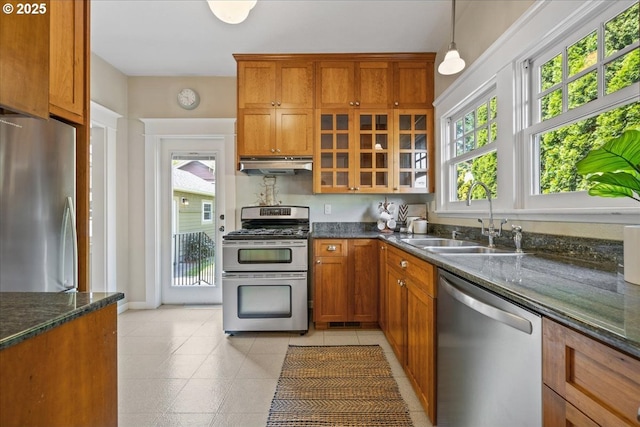 7525 SE 18th Ave, Portland, OR 97202 - kitchen featuring appliances with stainless steel finishes, under cabinet range hood, healthy amount of natural light, and brown cabinetry