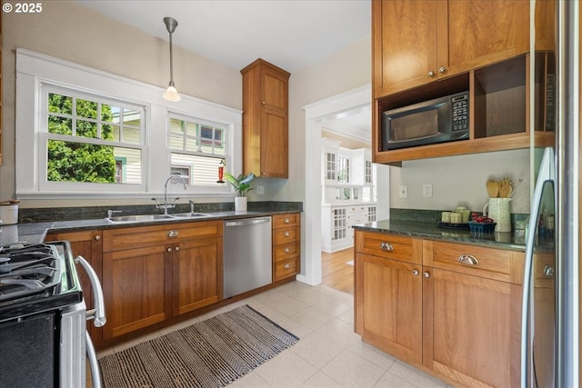 7525 SE 18th Ave, Portland, OR 97202 - kitchen with appliances with stainless steel finishes, hanging light fixtures, brown cabinetry, dark stone counters, and open shelves