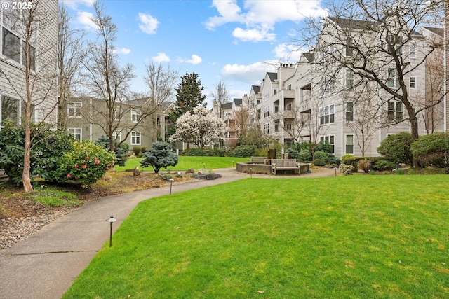 view of property's community featuring a yard and a residential view