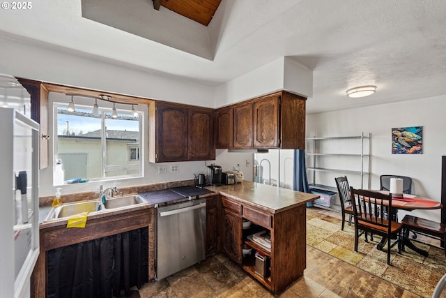 kitchen with a sink, dark brown cabinetry, stone finish flooring, a textured ceiling, and dishwasher