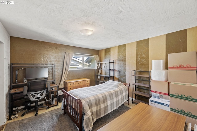 bedroom featuring a textured ceiling and a textured wall