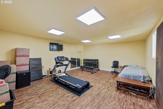 workout area with wood finished floors and baseboards