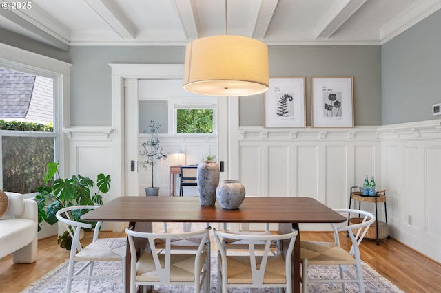 2215 NE 24th Ave, Portland, OR 97212 - dining room with a decorative wall, beamed ceiling, light wood-style floors, ornamental molding, and a wainscoted wall