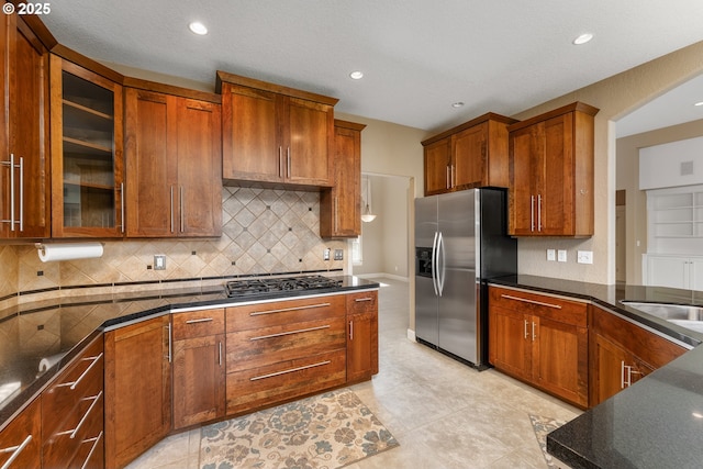 205 W Oriole Dr, Roseburg, OR 97471 - kitchen with recessed lighting, glass insert cabinets, backsplash, brown cabinets, and stainless steel appliances