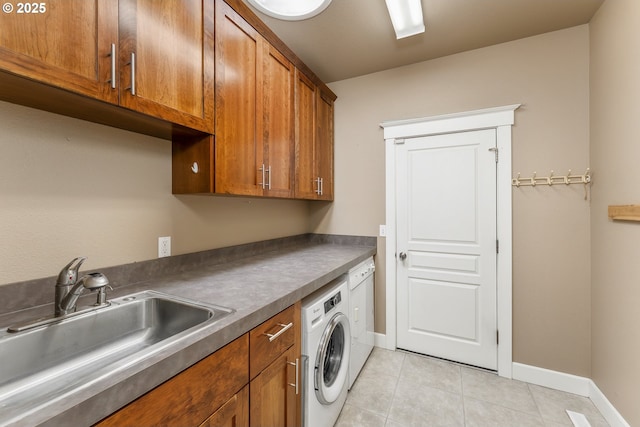 205 W Oriole Dr, Roseburg, OR 97471 - laundry area with light tile patterned flooring, a sink, washer / dryer, baseboards, and cabinet space