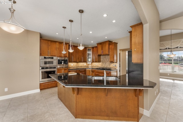 205 W Oriole Dr, Roseburg, OR 97471 - kitchen with stainless steel double oven, brown cabinets, light tile patterned flooring, and decorative backsplash