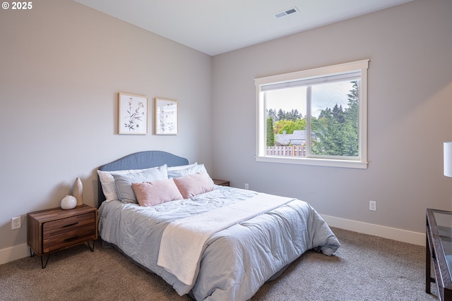 carpeted bedroom featuring baseboards and visible vents