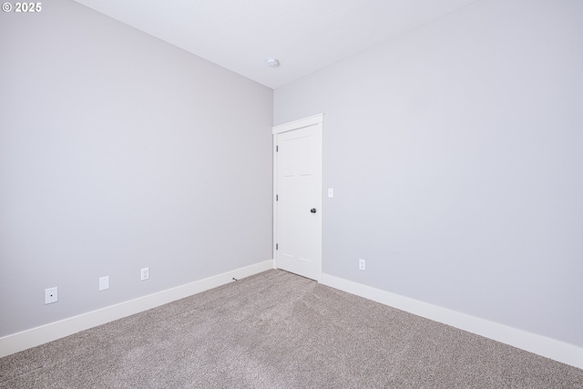 unfurnished room with baseboards and carpet floors