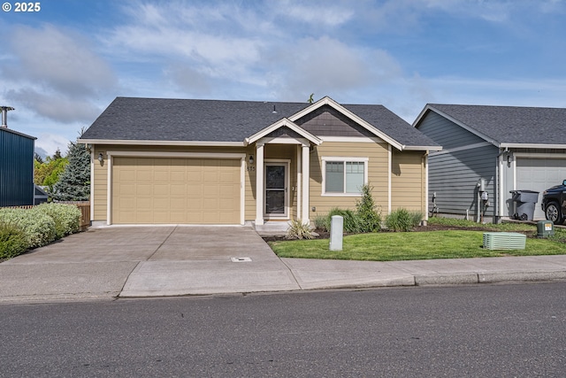view of front facade featuring an attached garage, driveway, and a front yard