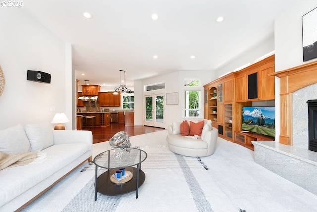 3830 NW 142nd Ter, Portland, OR 97229 - living room with a high end fireplace, recessed lighting, and a chandelier