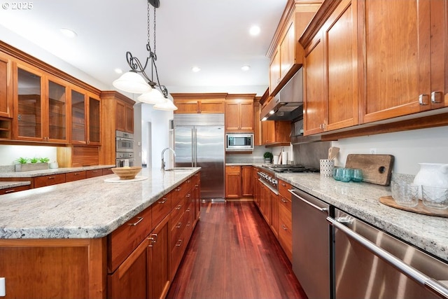 3830 NW 142nd Ter, Portland, OR 97229 - kitchen with built in appliances, brown cabinets, light stone countertops, and recessed lighting