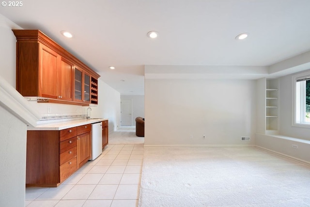 3830 NW 142nd Ter, Portland, OR 97229 - kitchen featuring white dishwasher, light carpet, a sink, open floor plan, and glass insert cabinets