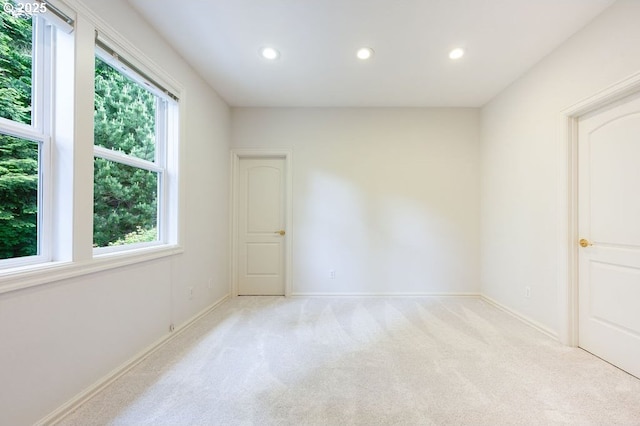 3830 NW 142nd Ter, Portland, OR 97229 - empty room featuring healthy amount of natural light, recessed lighting, light colored carpet, and baseboards