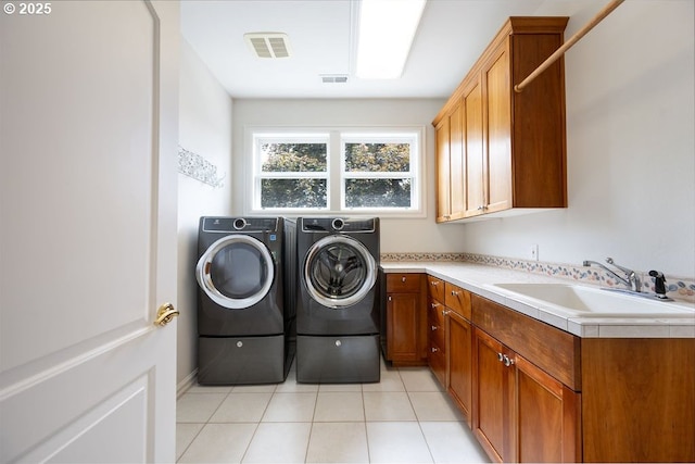 3830 NW 142nd Ter, Portland, OR 97229 - laundry room featuring washer and dryer, cabinet space, and light tile patterned floors