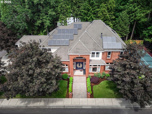 3830 NW 142nd Ter, Portland, OR 97229 - view of front of property with roof mounted solar panels, brick siding, and a front yard