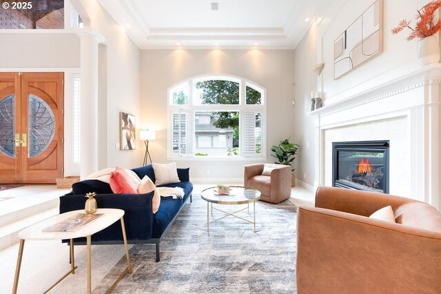 3830 NW 142nd Ter, Portland, OR 97229 - living area with a towering ceiling, crown molding, a glass covered fireplace, a raised ceiling, and recessed lighting