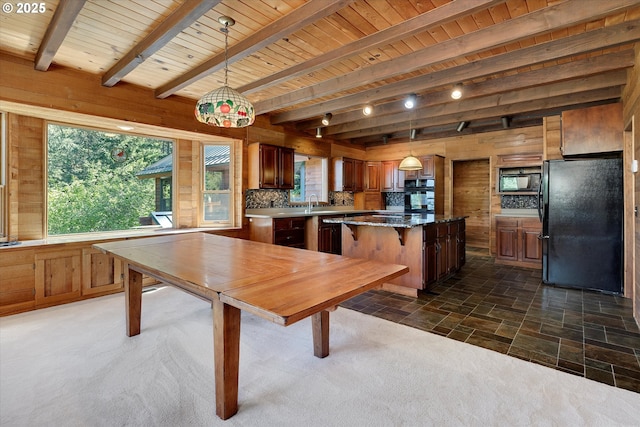kitchen with black appliances, a kitchen island, backsplash, beamed ceiling, and wood ceiling
