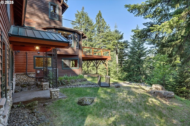 view of grassy yard featuring a deck