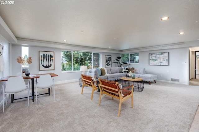 living room featuring light carpet, recessed lighting, visible vents, and baseboards