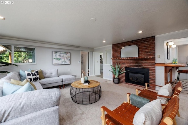 carpeted living area with a textured ceiling, recessed lighting, a fireplace, and crown molding