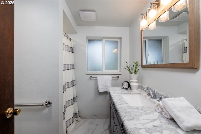 full bath with marble finish floor, curtained shower, vanity, and baseboards