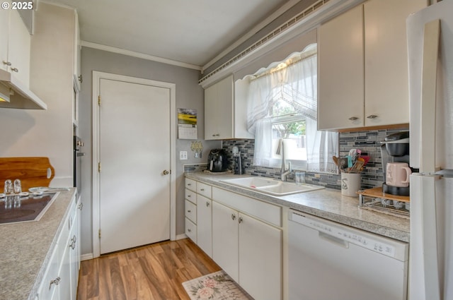 385 S Green St, Heppner, OR 97836 - kitchen with white appliances, backsplash, light wood-style floors, light countertops, and ornamental molding