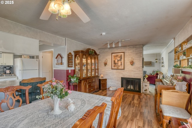 385 S Green St, Heppner, OR 97836 - dining space with a ceiling fan, wood finished floors, and a glass covered fireplace