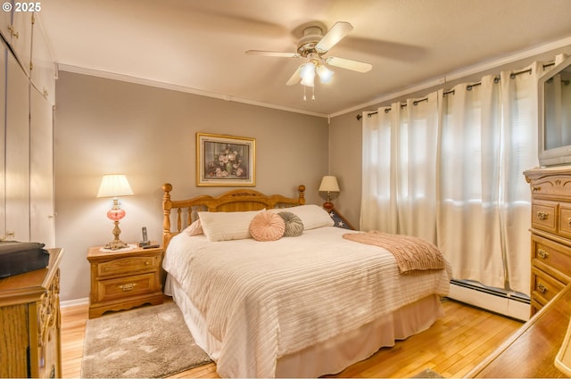 385 S Green St, Heppner, OR 97836 - bedroom with a baseboard heating unit, light wood-type flooring, ornamental molding, and ceiling fan