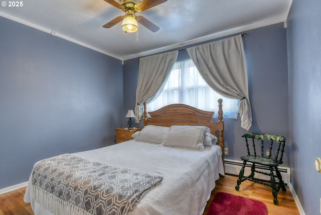 385 S Green St, Heppner, OR 97836 - bedroom with a baseboard heating unit, crown molding, wood finished floors, and ceiling fan