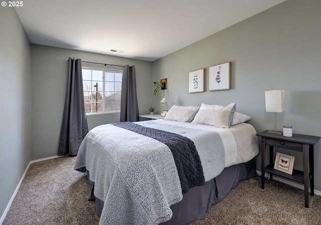 bedroom featuring visible vents, baseboards, and carpet