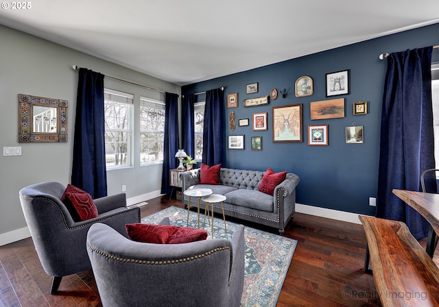 living area featuring baseboards and wood finished floors