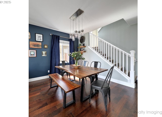 dining area featuring baseboards, stairway, and wood finished floors