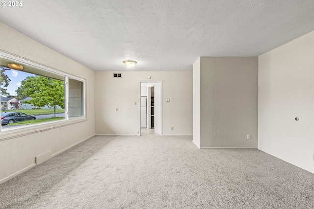 1041 19th Ave, Longview, WA 98632 - carpeted spare room with a textured ceiling and baseboards