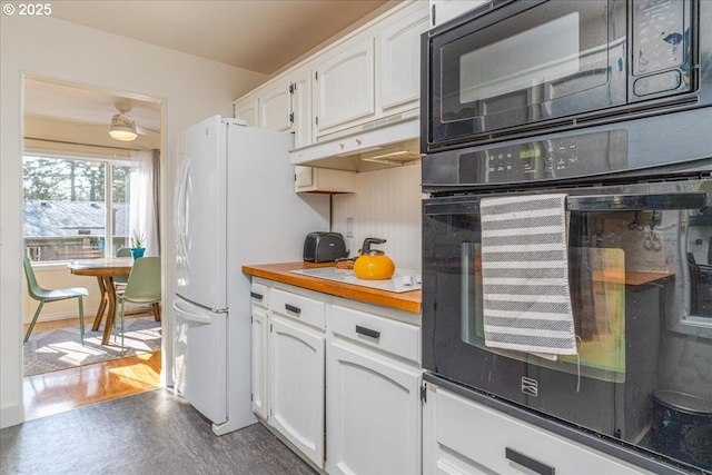 kitchen with white cabinetry, dark wood-type flooring, and black appliances