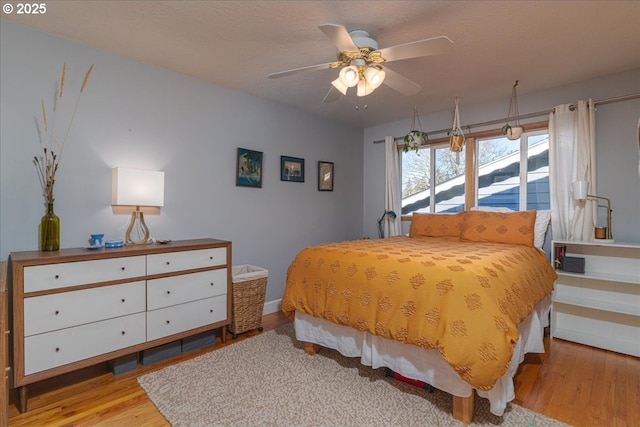 bedroom with ceiling fan and light wood-type flooring