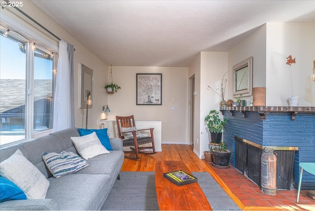 living room featuring a multi sided fireplace, hardwood / wood-style floors, and a textured ceiling