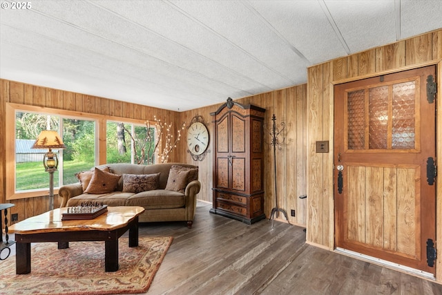 74576 Thompson Rd, Elgin, OR 97827 - living room with wood walls, a textured ceiling, and wood finished floors