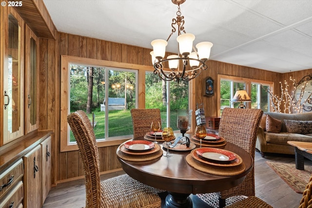 74576 Thompson Rd, Elgin, OR 97827 - dining space with wooden walls, a chandelier, and light wood-type flooring