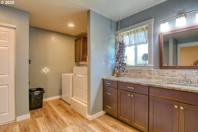 4303 SW Sheridan Ave, Pendleton, OR 97801 - bathroom with independent washer and dryer, vanity, wood finished floors, baseboards, and recessed lighting