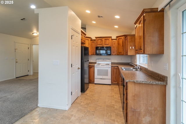 kitchen with sink, light colored carpet, black appliances, and lofted ceiling