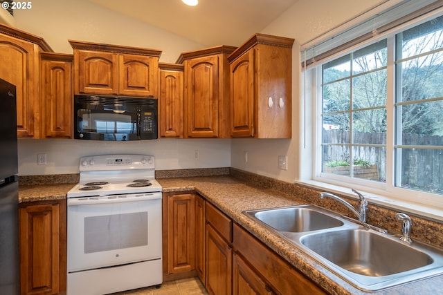 kitchen featuring white electric range, vaulted ceiling, and sink