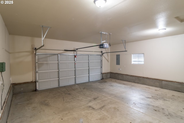 garage with electric panel and a garage door opener