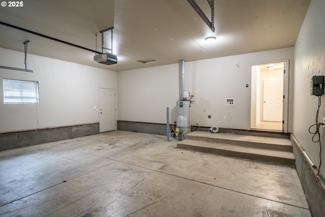 garage with gas water heater and a garage door opener