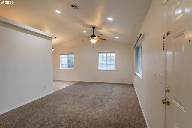 empty room with light carpet, vaulted ceiling, and ceiling fan